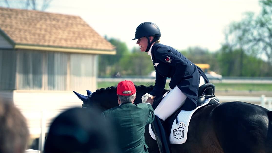 Rider laughing in the saddle after a round